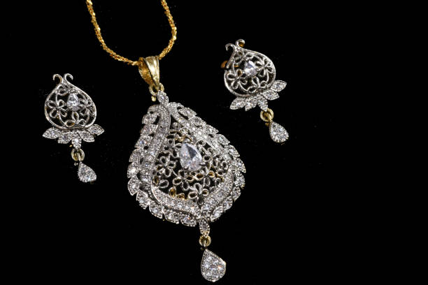 istock Fancy designer Diamond Chain pendent with earrings closeup macro image on black background 1045278332