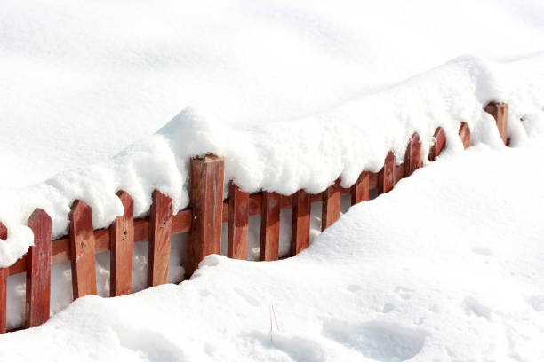 istock snow covered wood fence 1045278828