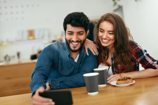 istock Happy People Using Phone In Cafe, Taking Photos 1045278982