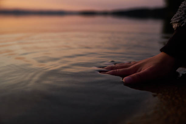 istock Human hand sink in the water from lake 1045279188