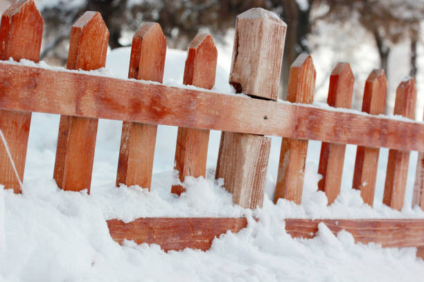 istock snow covered wood fence 1045279568
