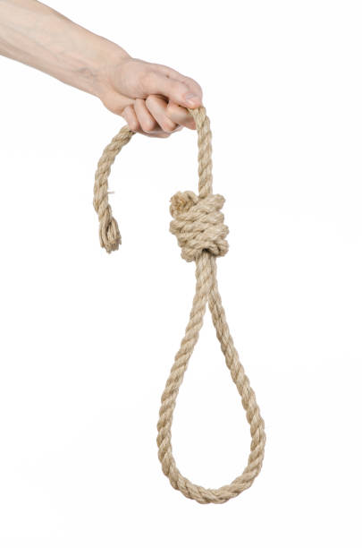 istock Lynching and suicide theme: man's hand holding a loop of rope for hanging on white isolated background 1045282524