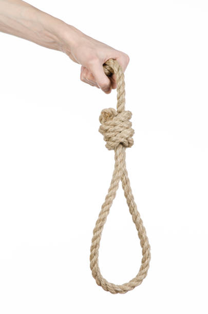 istock Lynching and suicide theme: man's hand holding a loop of rope for hanging on white isolated background 1045282608