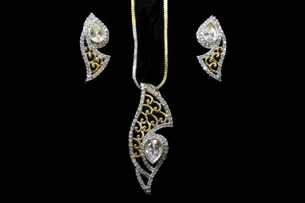 istock Fancy designer Diamond Chain pendent with earrings closeup macro image on black background 1045283074