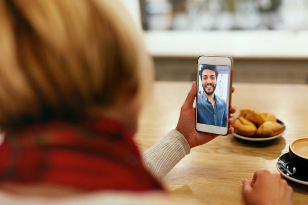 istock Face Call. Close Up Woman's Hand With Phone And Man On Video 1045283234