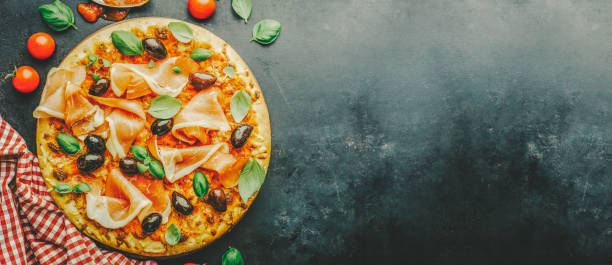 istock Traditional italian pizza on dark table 1045283406