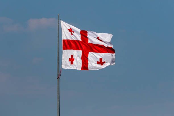 istock Georgia flag on blue sky background 1045283754