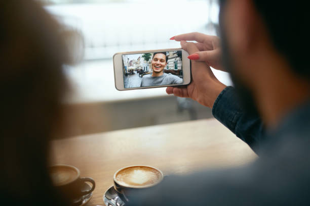istock Video Calling On Phone. Hand With Phone And Face On Screen 1045286238