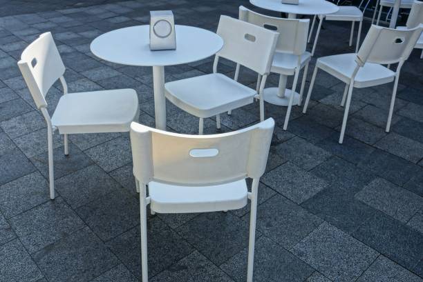 istock white plastic tables and chairs on the gray sidewalk 1045287008