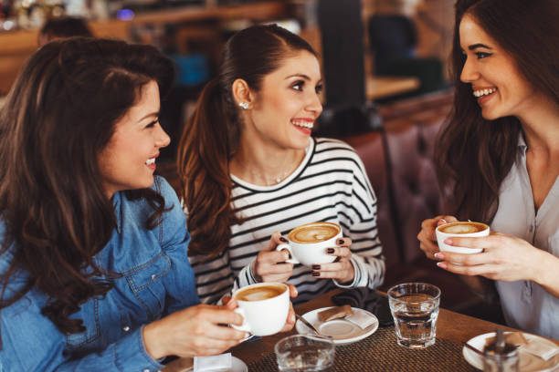 istock Three young women enjoy coffee at a coffee shop 1045293400
