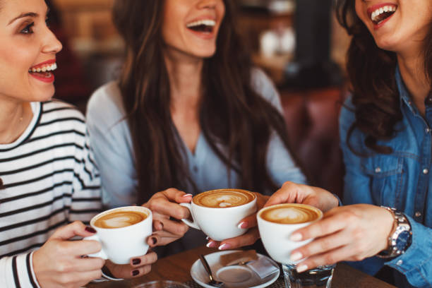 istock Three young women enjoy coffee at a coffee shop 1045297478