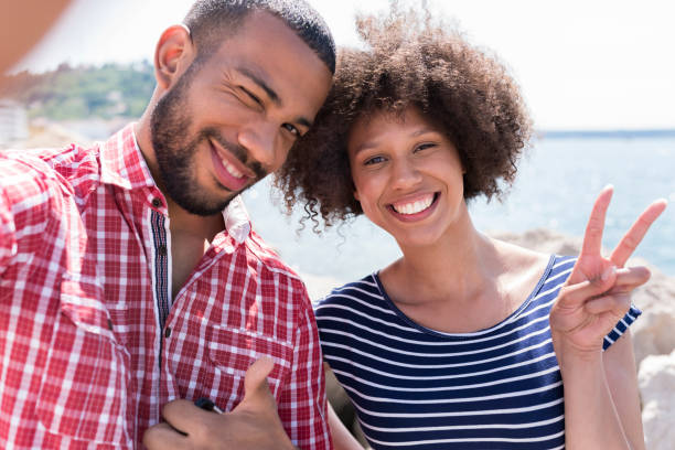 istock Smiling men and women taking selfie 1045297628