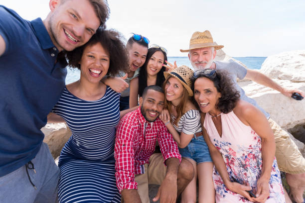 istock Friends taking selfie at beach 1045297652
