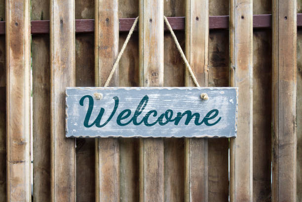 istock Wooden table with lettering or word Welcome 1045298282