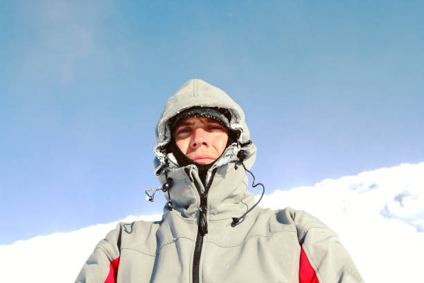 Winter hike in the mountains with a backpack and tent.