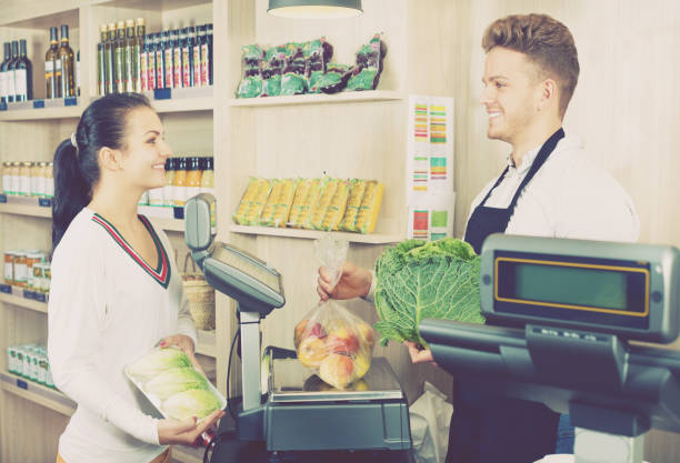 istock Male assistant helping customer in grocery shop 1045302388