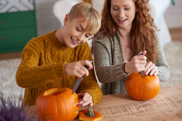 istock Friends carving pumpkins for Halloween 1045317732