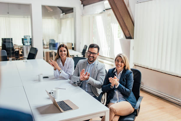 istock Coworkers applauding after presentation. Viewpoint. 1045322158