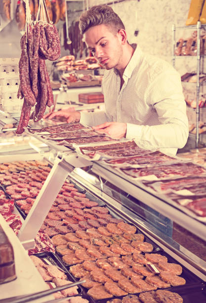 istock interested young male customer at butcher store 1045322946