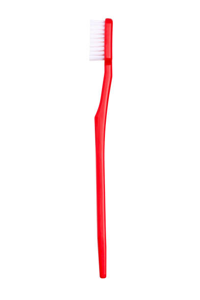 новая красная зубная щетка, крупным планом зрения - toothbrush стоковые фото и изображения