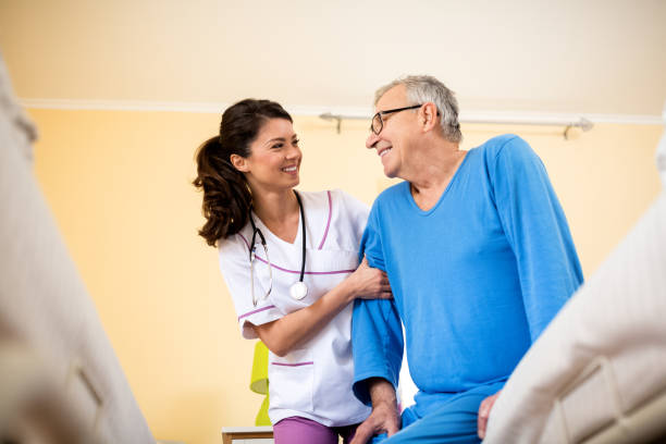 istock Nurse at nursing home helps senior man 1045328052