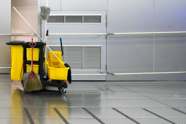 istock Yellow cleaning trolley park in walkway on stainless wall background. 1045328242