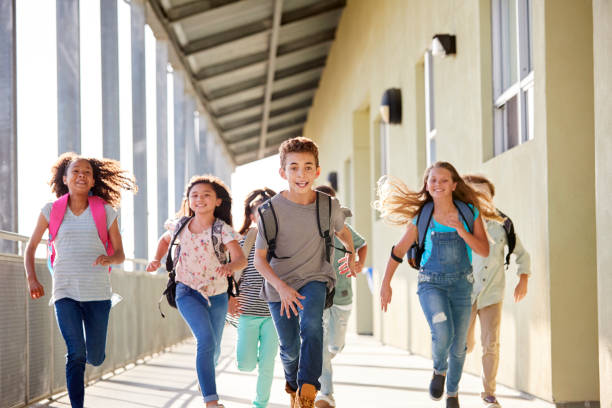 istock Kids running in elementary school corridor, close up 1045328408
