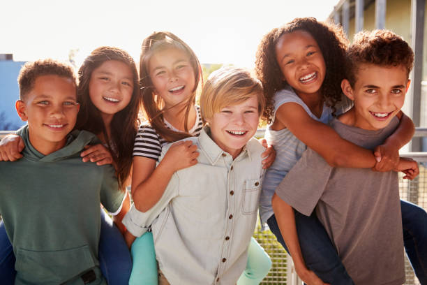 istock Elementary school kids smiling to camera at break time 1045328652