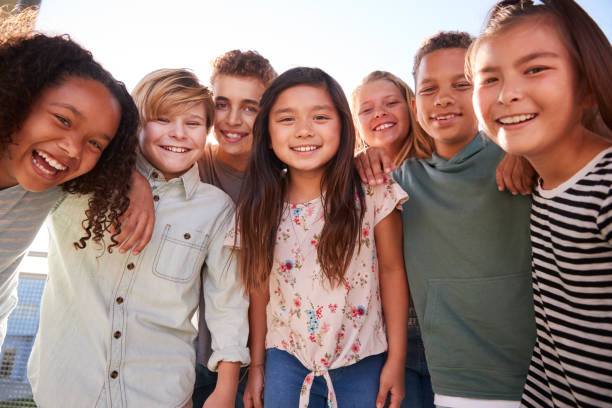 school kids hanging out during break, smiling to camera - pre adolescent child imagens e fotografias de stock