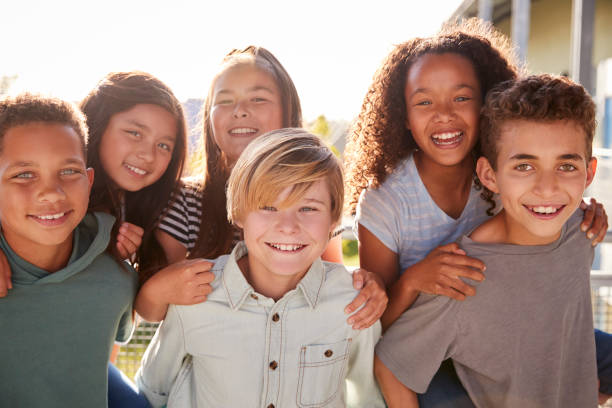 istock Elementary school kids smiling to camera during school break 1045328774