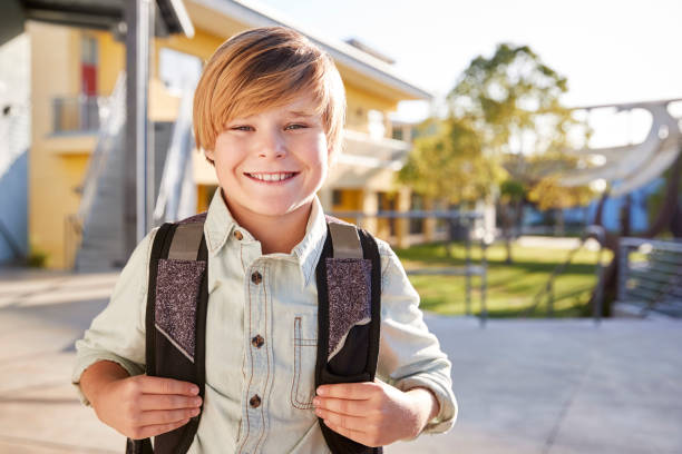 Portrait of smiling elementary school boy with his backpack