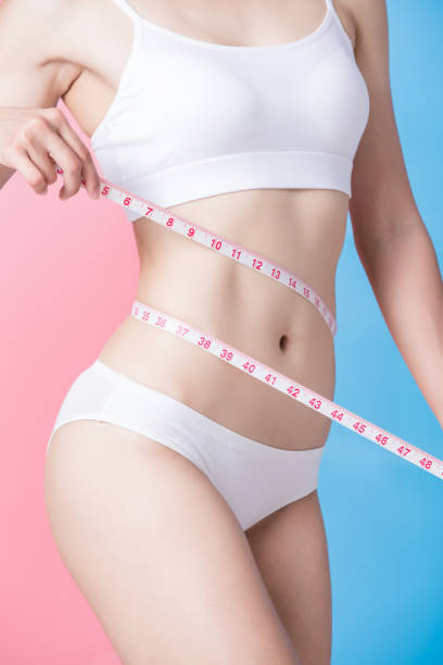 istock woman show her thin waist 1045331736
