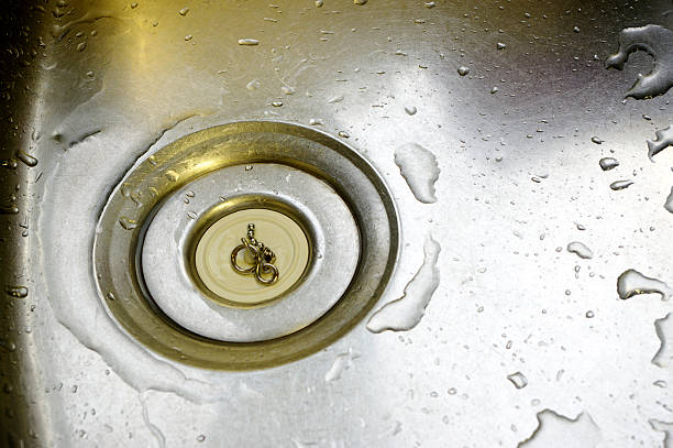 istock Water Drops Around Plughole With Plug In Stainless Steel Sink 104533202