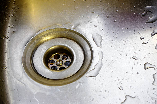 istock Water Drops Around Plughole In Stainless Steel Sink 104533205