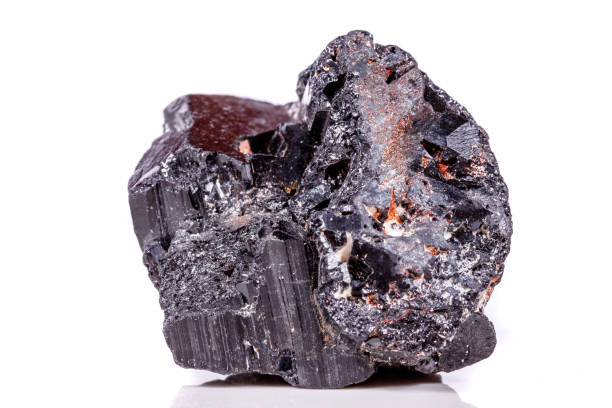 istock macro mineral stone sherle, schorl, black tourmaline on white background 1045335396