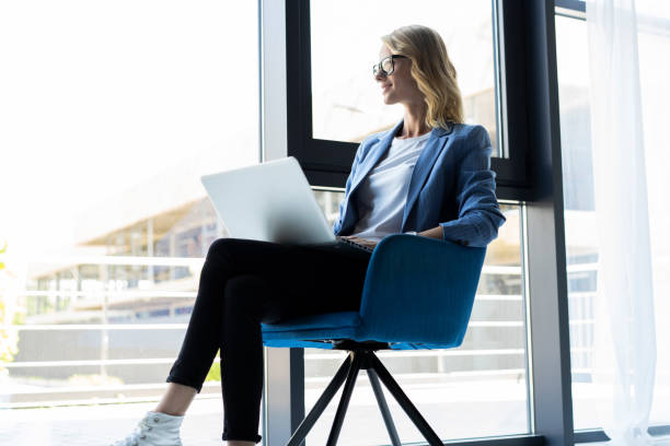 istock Hipster Woman use Laptop huge Loft Studio.Student Researching Process Work.Young Business Team Working Creative Startup modern Office.Analyze market stock,new strategy.Blurred,film effect.Horizontal 1045335496