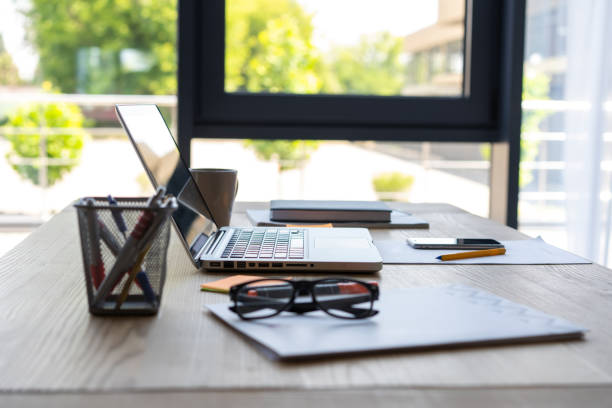 istock Office workplace with laptop and smart phone on wood table. 1045338566