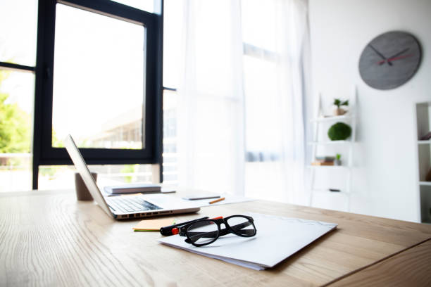 istock Office workplace with laptop and smart phone on wood table. 1045338572