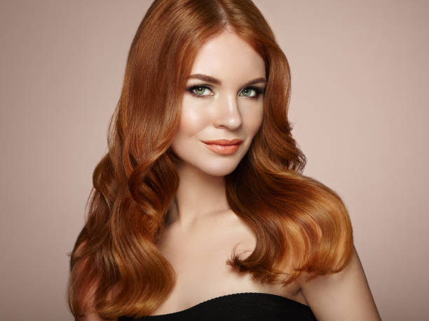 rothaarige frau mit lockigem haar - long red hair stock-fotos und bilder