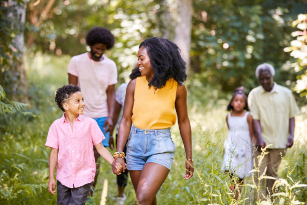 istock Black mother and son walking in woods looking at each other 1045342538