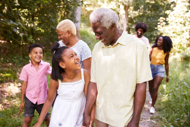 istock Multi generation black family walking in forest, close up 1045342618