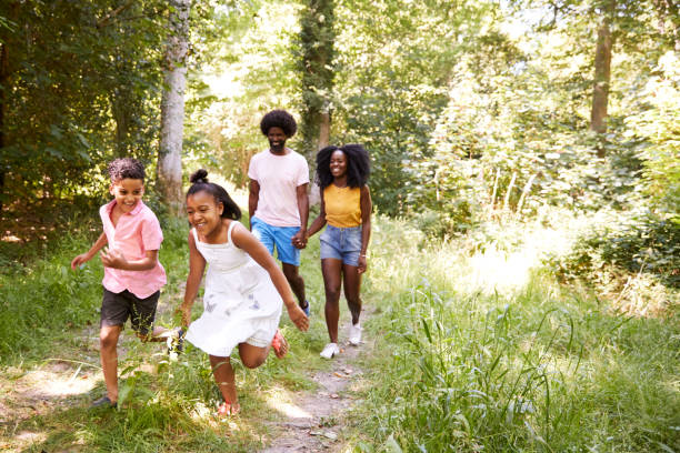 istock A black couple and their two kids walking in a forest 1045343572