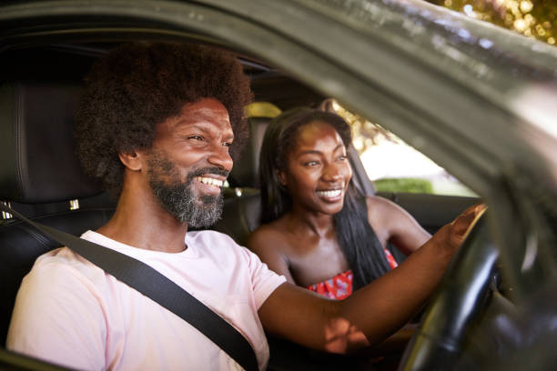 istock Two young black adults sitting in a car during road trip 1045343752