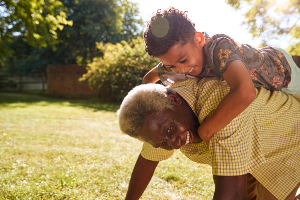 istock Senior black man with grandson riding on his back 1045344028