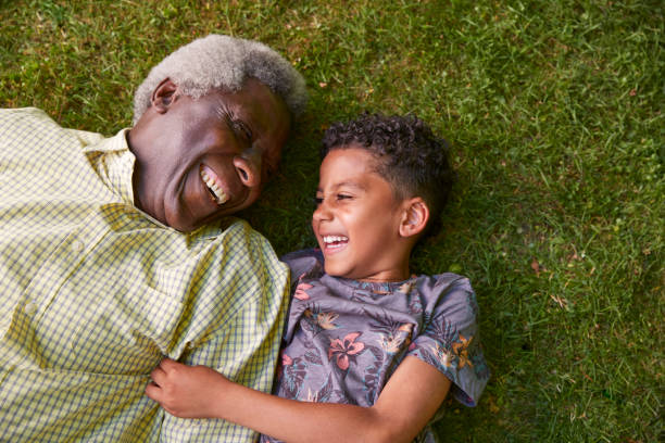 istock Boy and his granddad lying on grass, overhead close up 1045344038