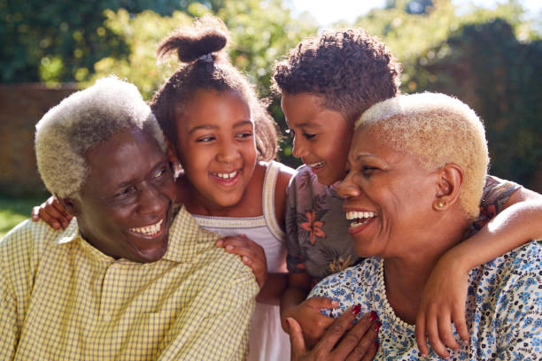 Senior black couple and grandchildren outdoors, close up Senior black couple and grandchildren outdoors, close up happiness four people cheerful senior adult stock pictures, royalty-free photos & images