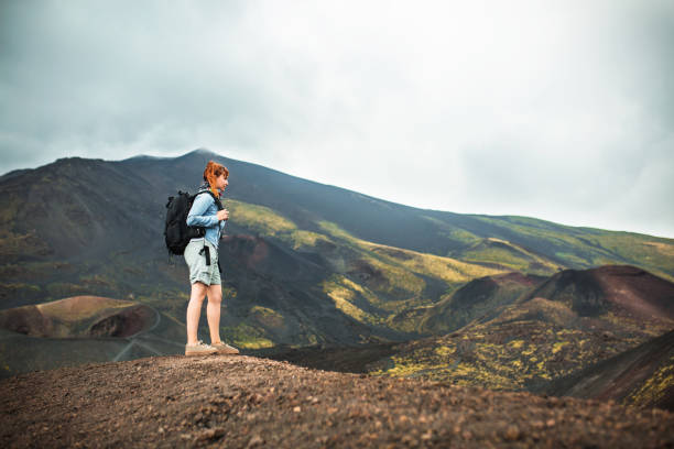 Young woman hiking alone on Etna volcano