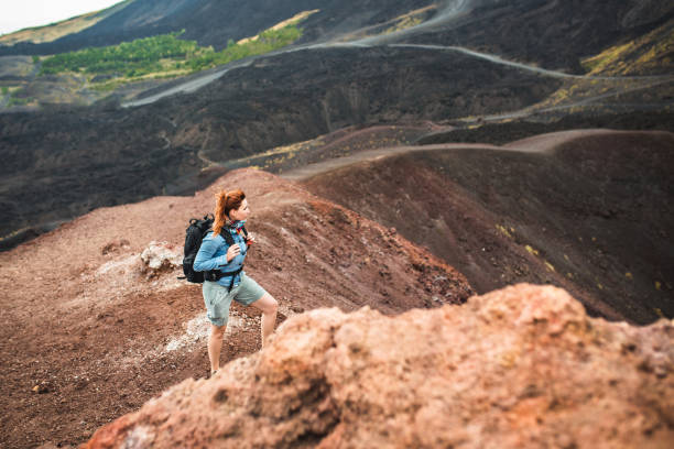 Sucessful hiking adventure Young woman hiking alone on Etna volcano mt etna stock pictures, royalty-free photos & images