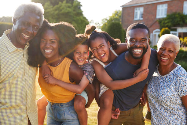 istock Multi generation black family, parents piggybacking kids 1045347974