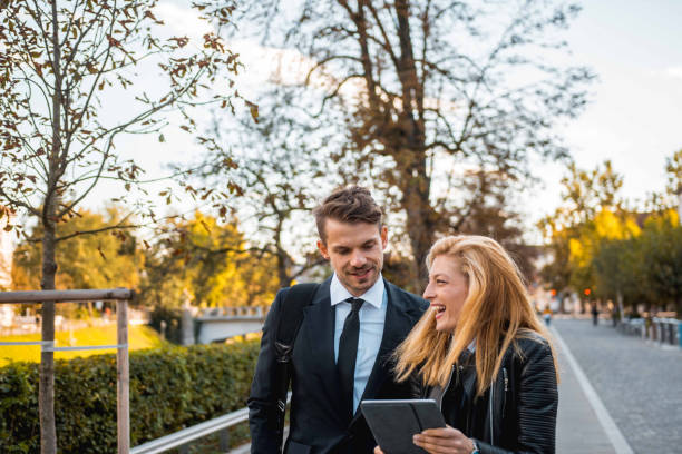 istock Businesspeople using a digital tablet and walking in the city 1045348000